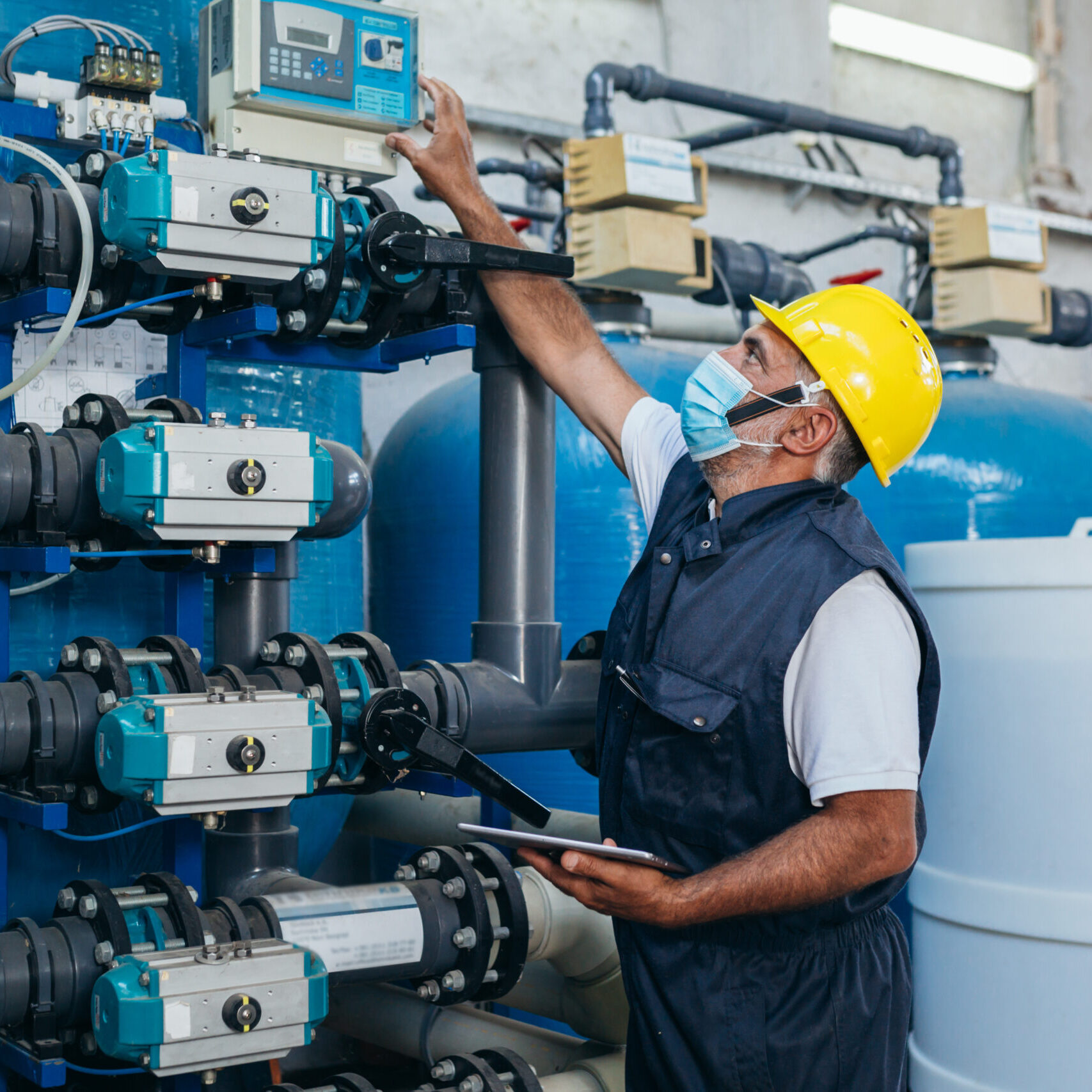 industry worker checking chemical water treatment equipment industry worker checking chemical water treatment equipment